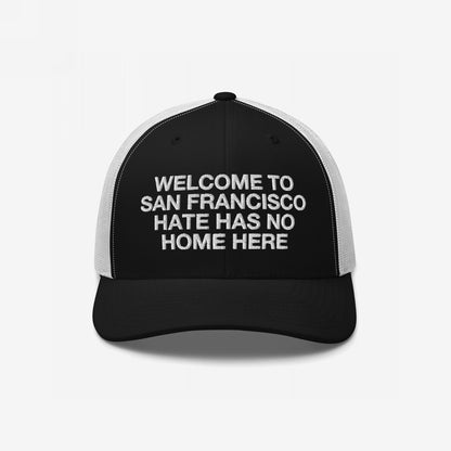 Custom Hate Has No Home Here Trucker Hat featuring customizable welcome message with breathable mesh and adjustable snap closure for comfort.