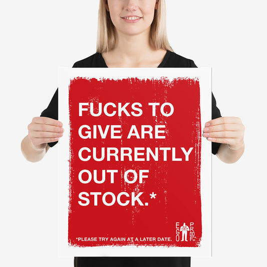 Person holding a Fucks To Give Giclée Print poster with bold white text on a red background, embodying burnout and sarcasm. Features Ego Proof Co. logo in the corner for Egoproof's mental health advocacy.