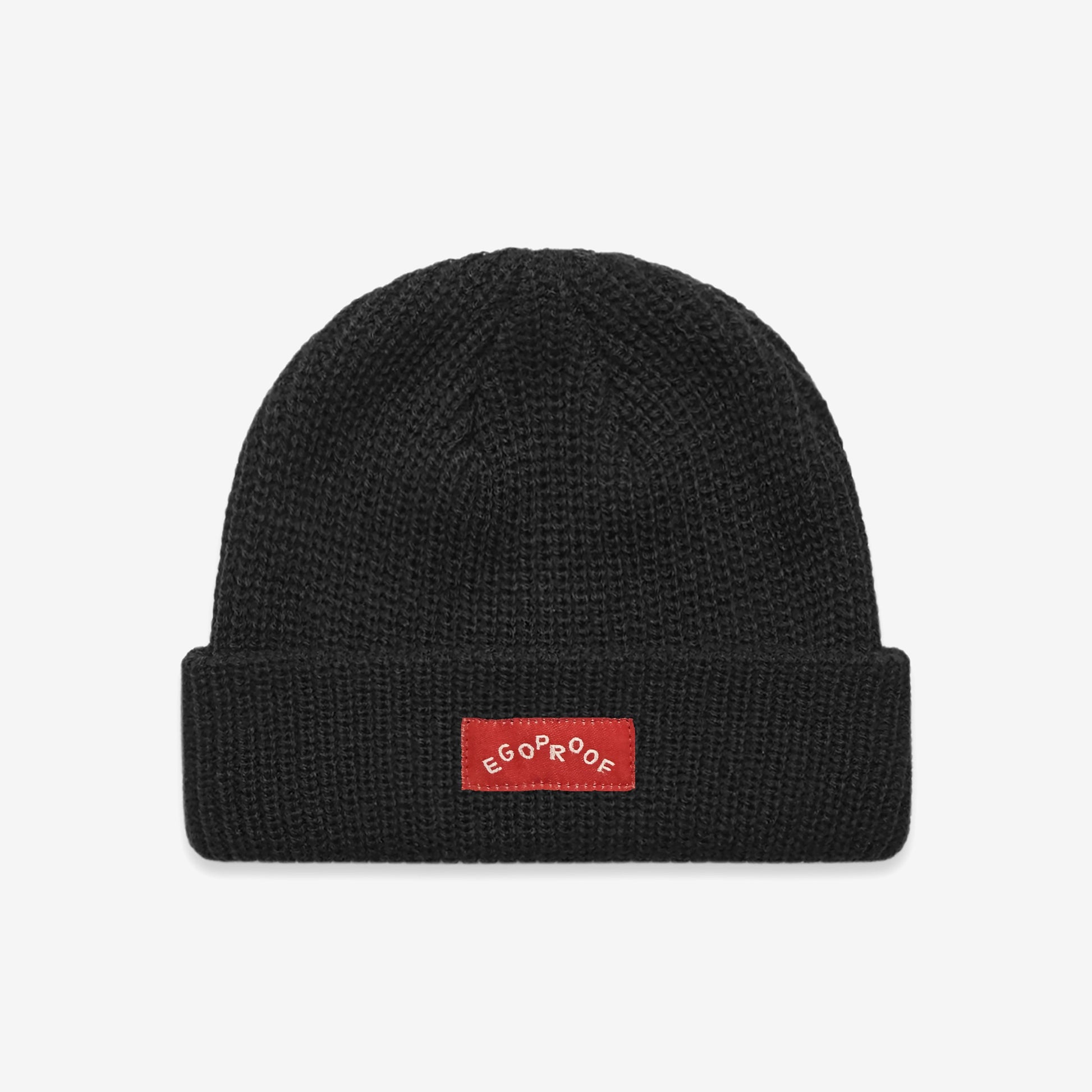 Go Fish Beanie: A black, mid-weight fisherman-style beanie with a woven EGOPROOF label, featuring wide ribbed cable knit. Designed for warmth and comfort, reflecting Egoproof's mental health awareness ethos.