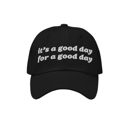 The Good Day Hat features a black baseball-style cap with “it’s a good day for a good day.” embroidered in white, embod
