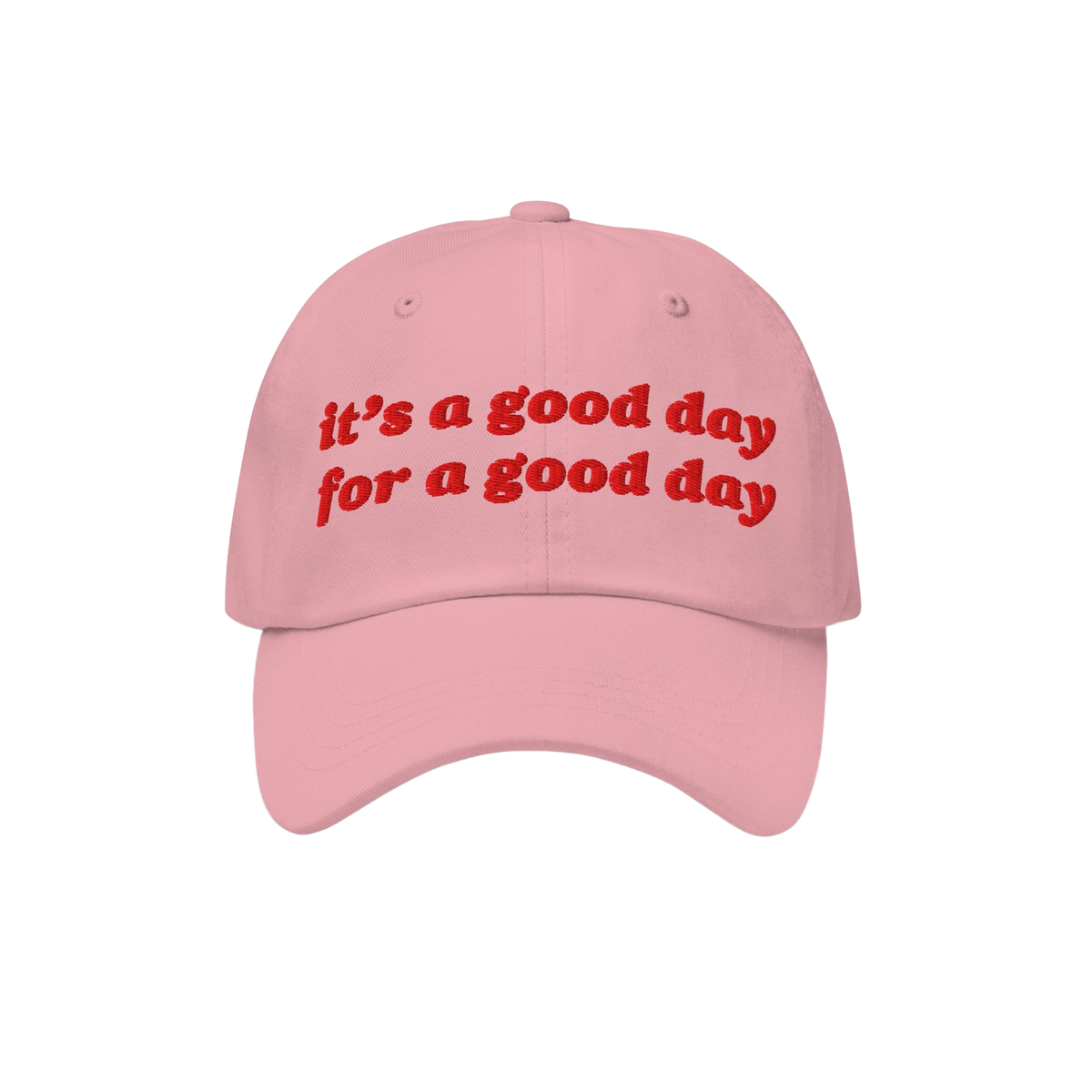 Good Day Hat features a light-pink dad hat with red embroidered text, it's a good day for a good day, promoting positivity an