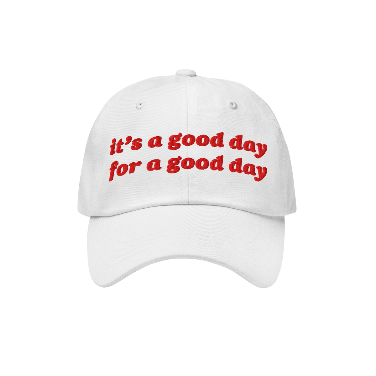 White baseball-style cap with red embroidered text reading “it’s a good day for a good day.” The Good Day Hat embodies 