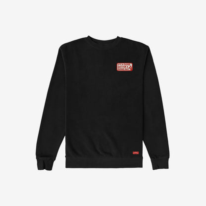 Good Day Sweatshirt: Black crewneck with a red-and-white patch on the chest stating, IT’S A GOOD DAY FOR A GOOD DAY, embodying subtle positivity and mental health awareness.