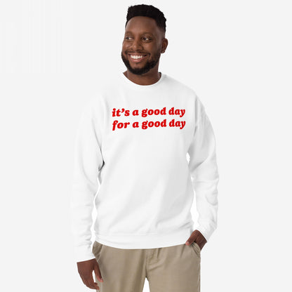 Smiling man wearing the Good Day Sweatshirt EU with bold red lettering, embodying comfort and optimism. Ideal for those embracing positivity and mental health awareness. Perfect for gifting or inspiring daily.