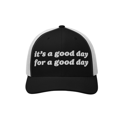 The Good Day Hat features a black-and-white mesh-back design with the phrase it’s a good day for a good day embroidered on 