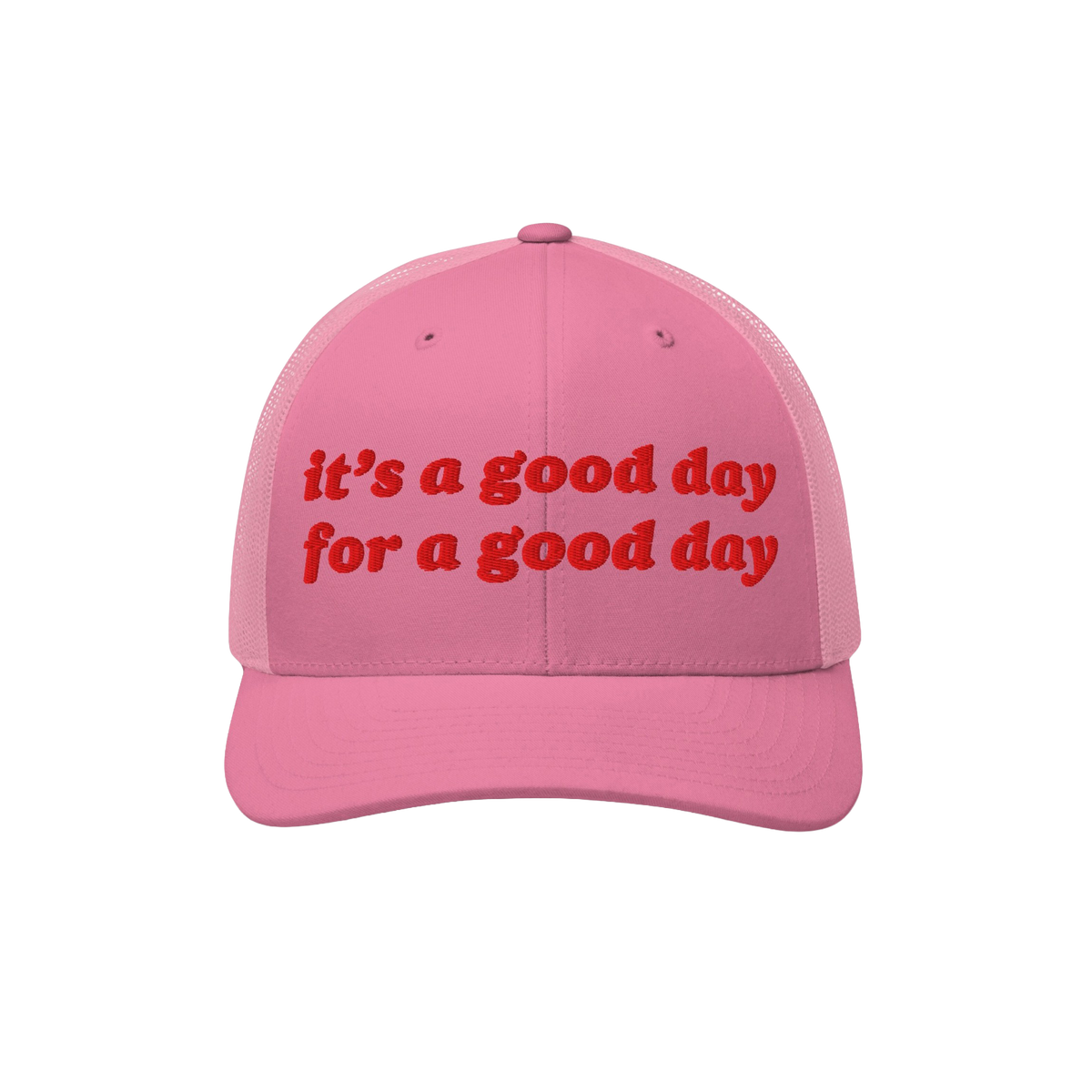 Pink trucker-style baseball cap featuring red embroidered text: “it’s a good day for a good day.” The Good Day Hat embo