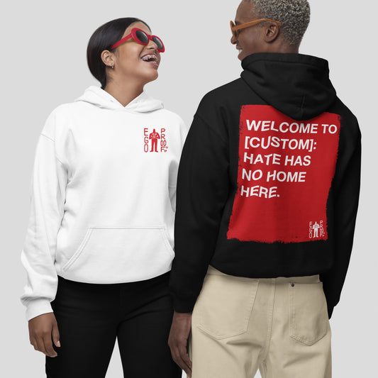 Two models wear the Custom Hate Has No Home Here Hoodie. The left features a red EGO PROD. logo, while the right showcases a bold red square with an inclusive message on the back.