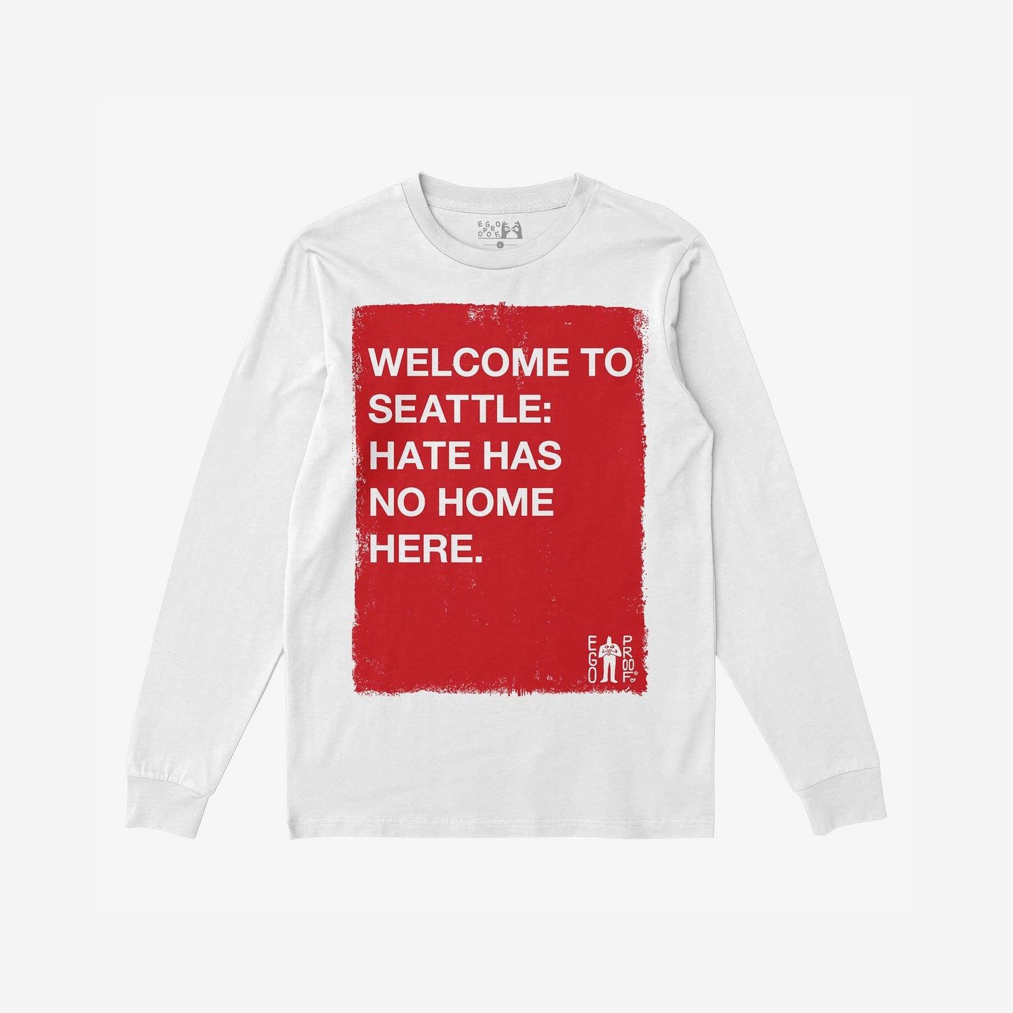 Custom Hate Has No Home Here Long Sleeve T-shirt featuring a distressed red square with bold white text, promoting inclusivity. EGO PROOF branding adds authenticity. Personalize with your city for a unique statement.