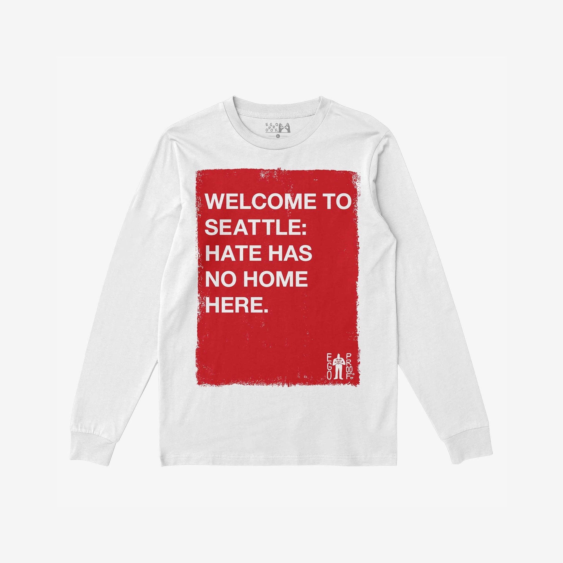 Custom Hate Has No Home Here Long Sleeve T-shirt featuring a distressed red square with bold white text, promoting inclusivity. EGO PROOF branding adds authenticity. Personalize with your city for a unique statement.