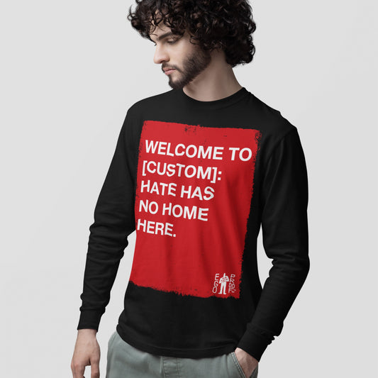 Custom Hate Has No Home Here Long Sleeve T-shirt features a bold red rectangle with a powerful message, worn by a young man with curly hair, embodying Egoproof's advocacy for unity and acceptance.