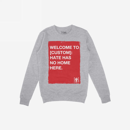 Custom Hate Has No Home Here Sweatshirt featuring a bold red rectangle with anti-hate slogan in white, ideal for those who stand against division. Includes customizable community name.