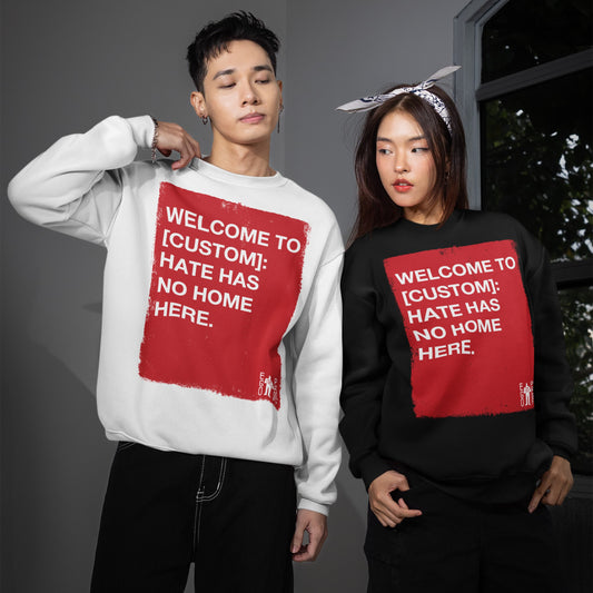 Two models showcase the Custom Hate Has No Home Here Sweatshirt, highlighting its bold anti-hate message. The design, on both white and black crew-necks, emphasizes conviction and community empowerment.