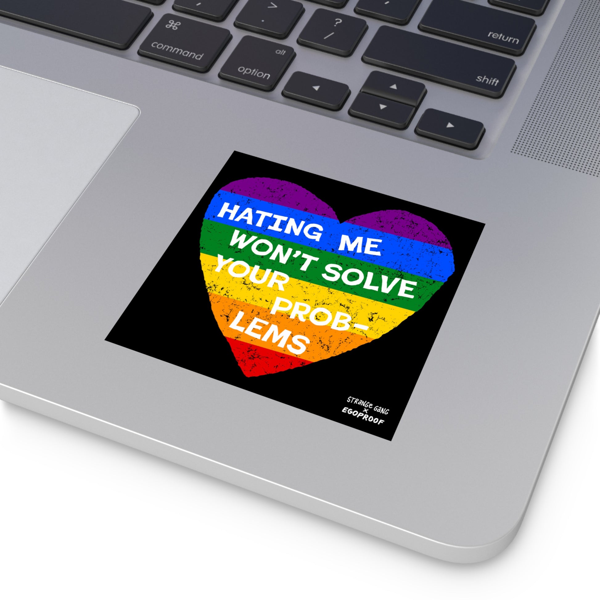 No LGBTQ Hate Sticker & Magnet showing a rainbow heart with "Hating Me Won't Solve Your Problems" phrase on a laptop surface.