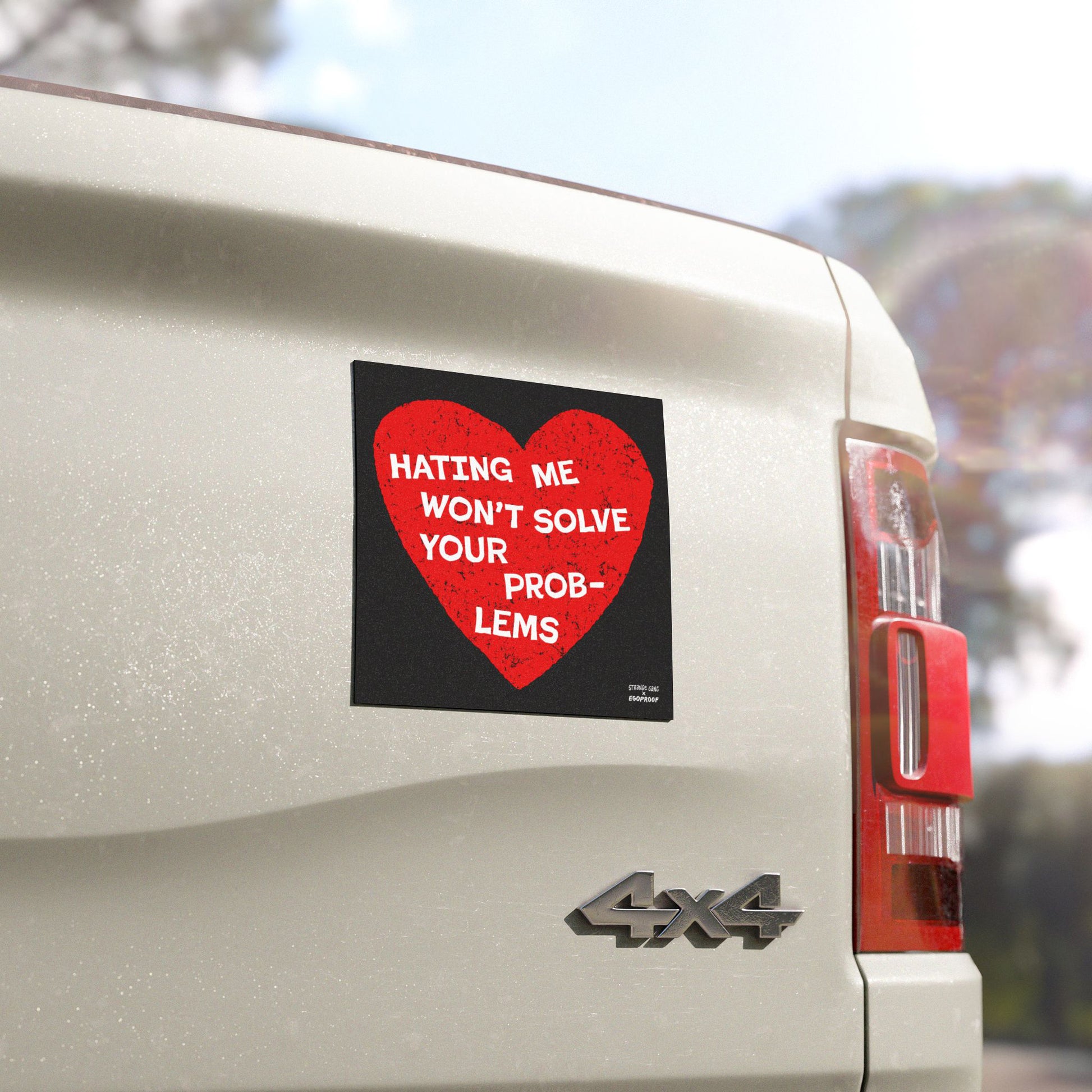 No Hate Sticker & Magnet with red heart and message "Hating Me Won't Solve Your Problems" on white 4x4 vehicle tailgate.