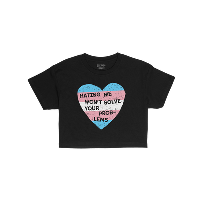 No Trans Hate Women's Baby Tee in black with trans pride heart and slogan "Hating Me Won't Solve Your Problems" on front.