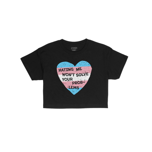 No Trans Hate Women's Baby Tee in black with trans pride heart and slogan "Hating Me Won't Solve Your Problems" on front.