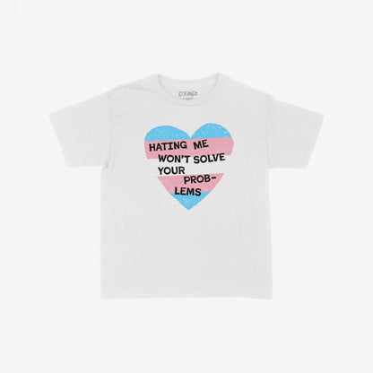No Trans Hate Kids T-shirt EU featuring a bold heart with trans flag stripes and the empowering slogan, “Hating Me Won’t Solve Your Problems.” Designed to inspire pride and confidence in children.
