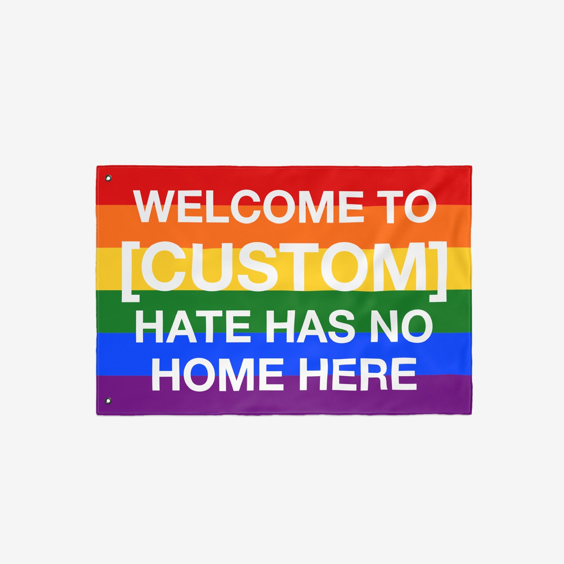 Custom Hate Has No Home Here Pride Flag with rainbow stripes, customizable text space, and grommets for hanging. Promotes inclusivity and LGBTQ+ acceptance, available in various sizes.