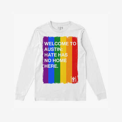 Custom Hate Has No Home Here Pride Long Sleeve T-shirt featuring a vertical rainbow brush stroke design with bold white text promoting inclusivity. Includes EGO PROOF logo. Perfect for events or everyday wear.