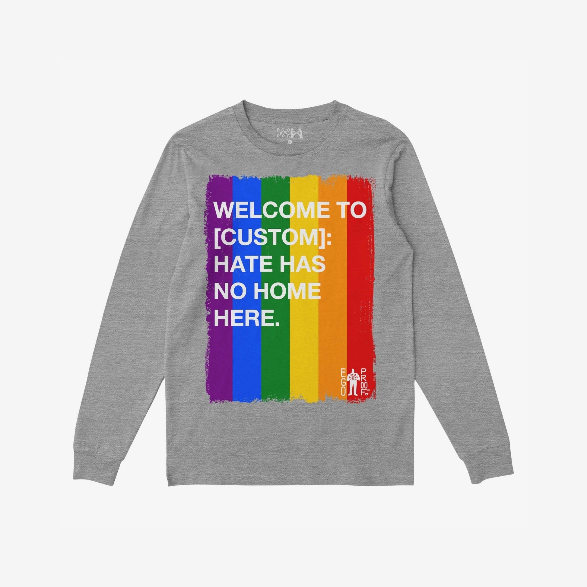 Custom Hate Has No Home Here Pride Long Sleeve T-shirt featuring a painted rainbow-stripe rectangle with WELCOME TO [CUSTOM]: HATE HAS NO HOME HERE in white letters, embodying inclusivity and empowerment from Egoproof.