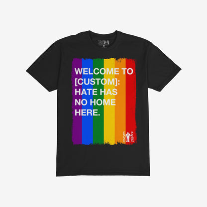 Custom Hate Has No Home Here Pride T-shirt featuring bold white text over rainbow stripes, customizable with your community name. Ideal for promoting unity and acceptance. Includes a small EGO PROOF logo.