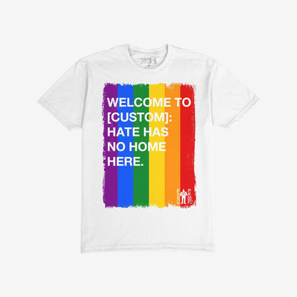 Custom Hate Has No Home Here Pride T-shirt featuring a brushed rainbow-stripe rectangle with bold text, customizable with your city name. Includes “EGOPROOF.” logo, embodying unity and acceptance.