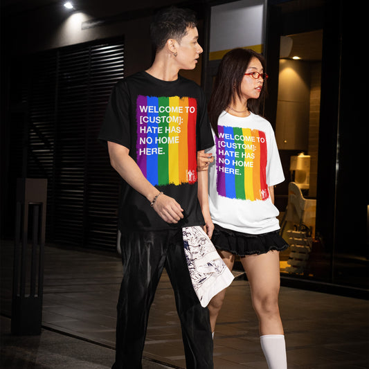 Custom Hate Has No Home Here Pride T-shirt features a bold rainbow stripe design, worn by a young man and woman in an urban nighttime setting, embodying unity and acceptance.