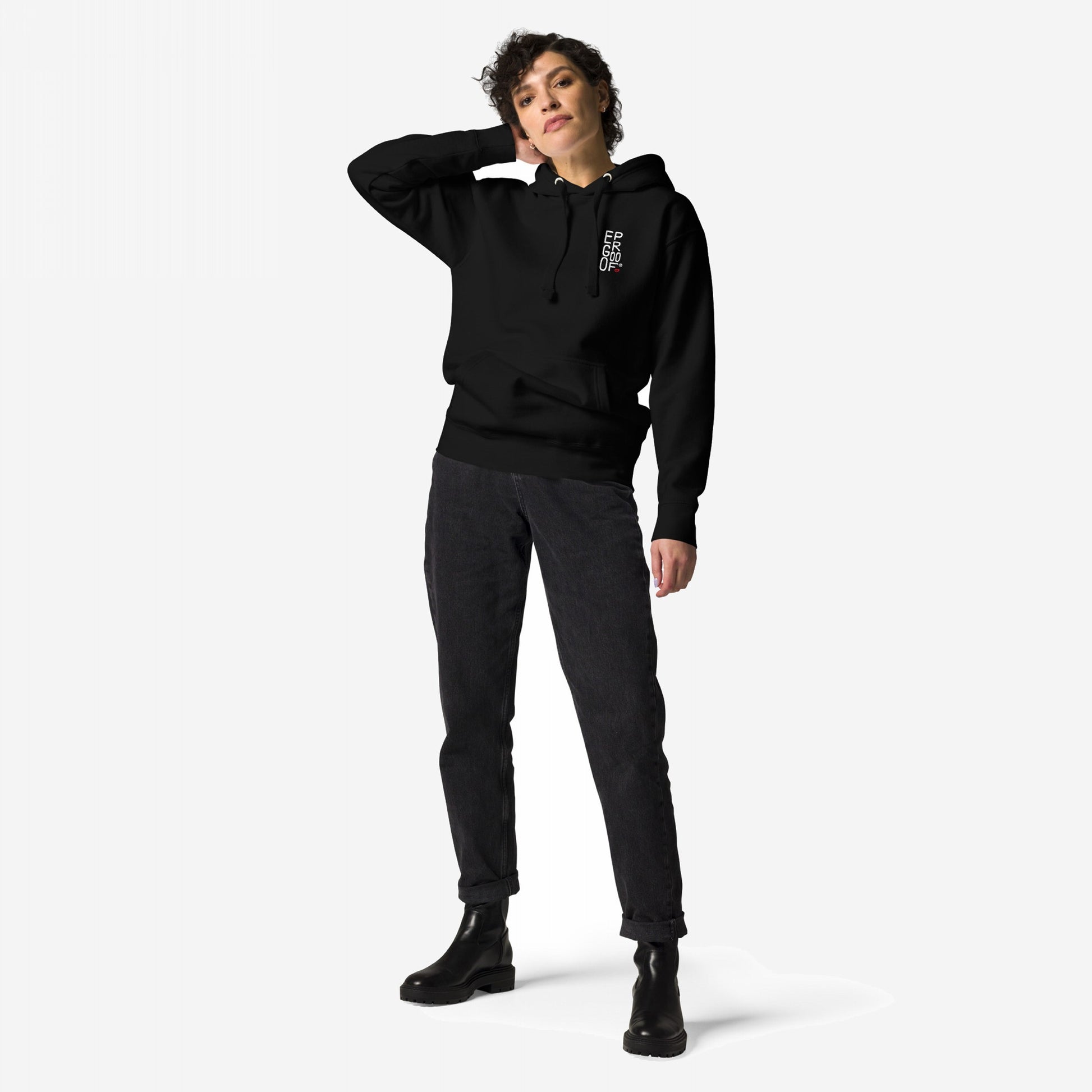 Make Art Every Day Hoodie EU featured on a person standing, showcasing the black pullover with a small white chest graphic, paired with dark jeans and chunky ankle boots, embodying creative expression.