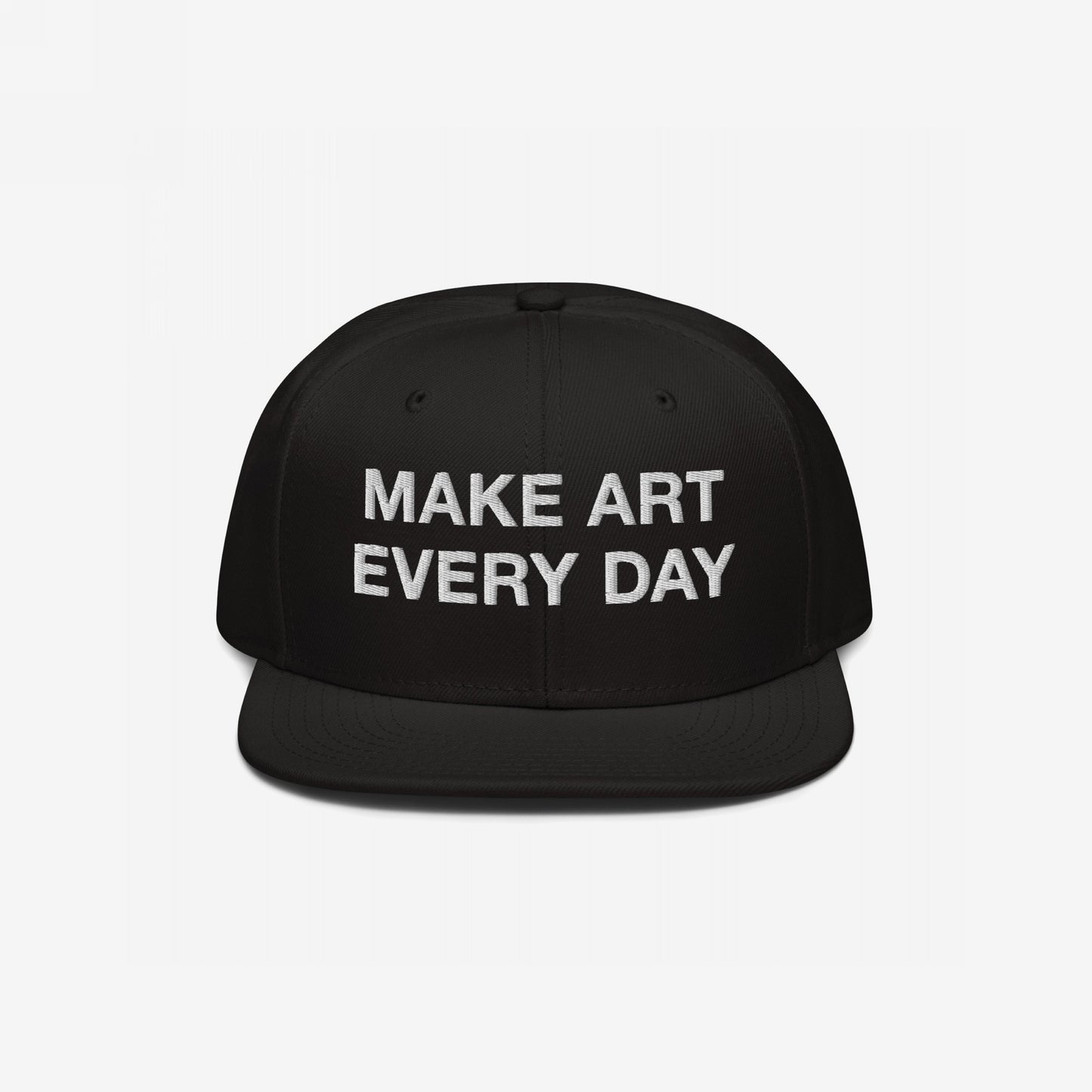 Black flat-brim snapback cap titled Make Art Every Day featuring bold white embroidered message, encouraging creativity and persistence. Includes adjustable fit and additional back embroidery for versatile, everyday wear.
