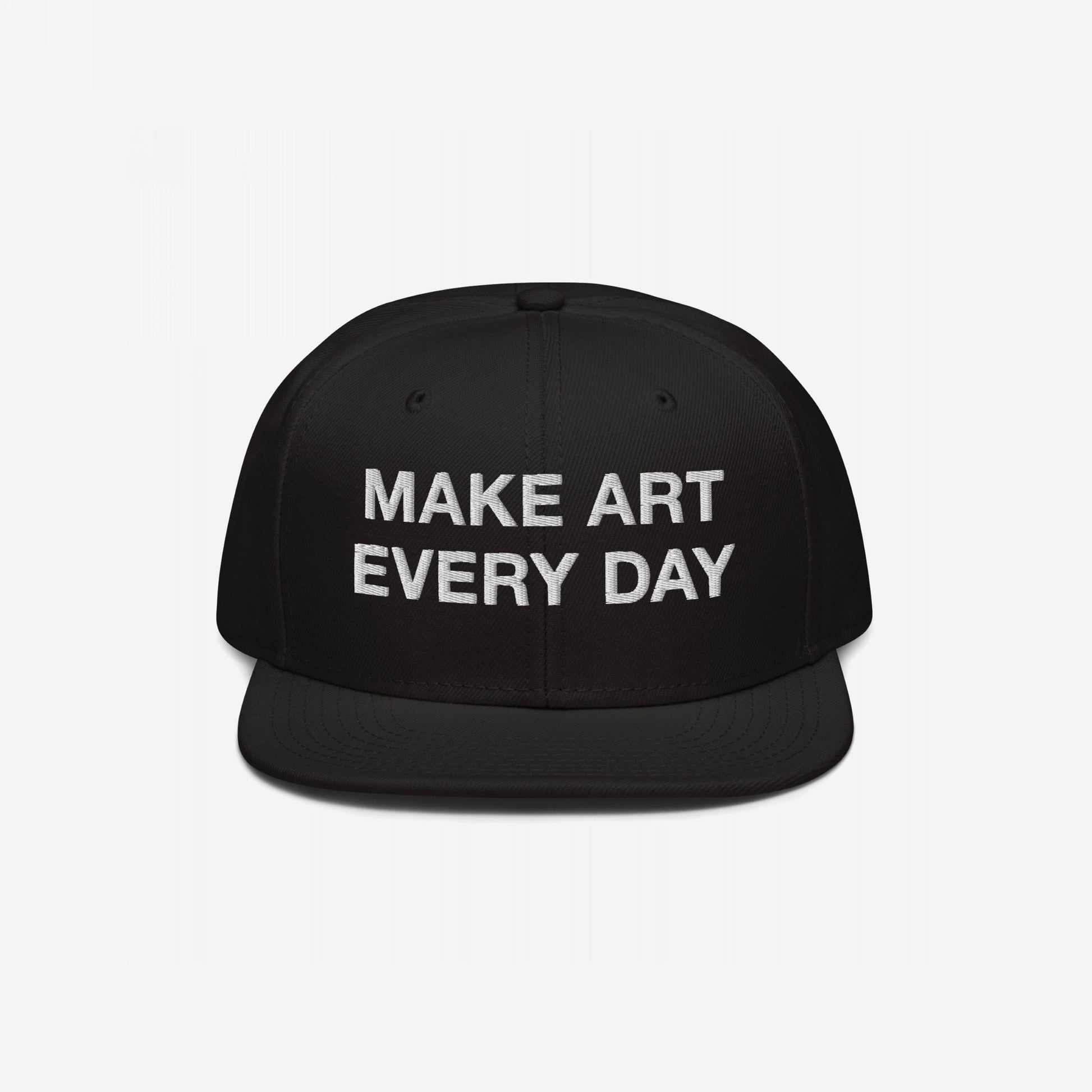 Black flat-brim snapback cap titled Make Art Every Day featuring bold white embroidered message, encouraging creativity and persistence. Includes adjustable fit and additional back embroidery for versatile, everyday wear.