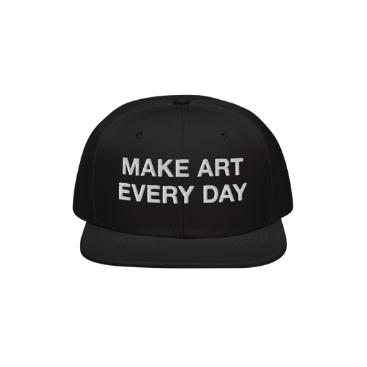 Black flat-brim snapback cap titled Make Art Every Day featuring bold white embroidered message, encouraging creativity and p