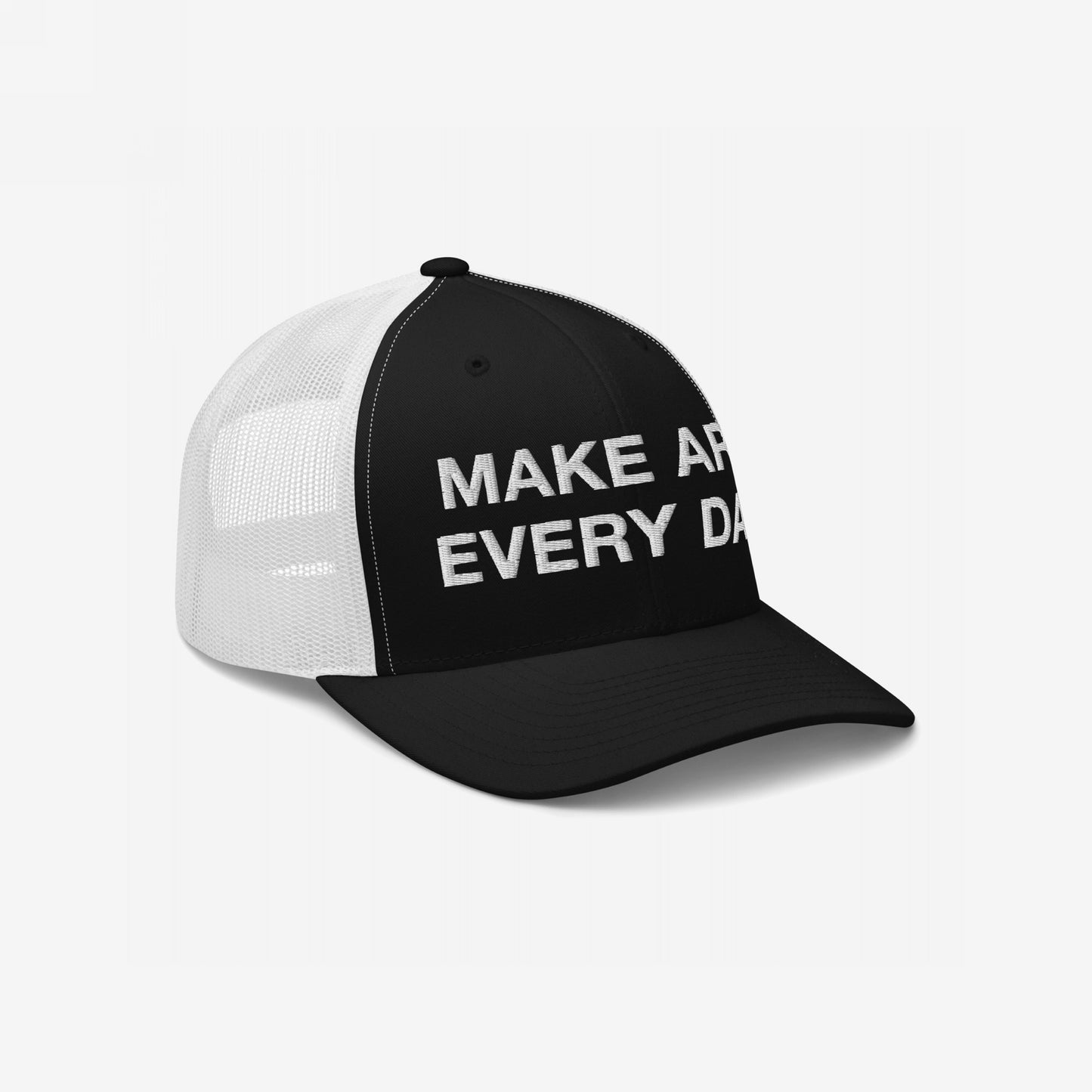 The Make Art Every Day Hat features a two-tone trucker design with a black front panel and white mesh, showcasing the embroidered message MAKE ART EVERY DAY to inspire creativity and persistence.