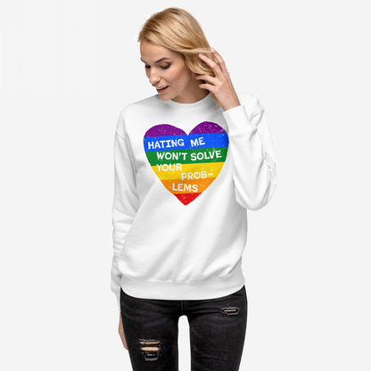 A blonde woman wears the No LGBTQ Hate Sweatshirt EU, featuring a distressed rainbow heart with the slogan HATING ME WON’T SOLVE YOUR PROBLEMS, paired with black ripped jeans.