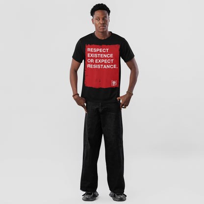 Young man in a Respect Existence T-shirt, featuring a bold red square with a powerful slogan. He pairs it with loose black jeans and sneakers, embodying resistance and awareness.