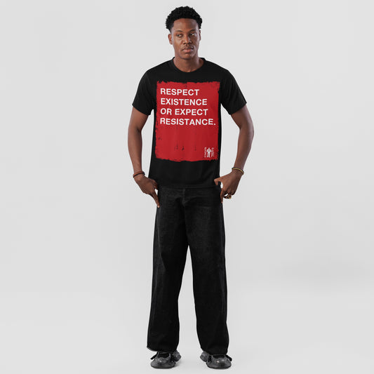 Young man in a Respect Existence T-shirt, featuring a bold red square with a powerful slogan. He pairs it with loose black jeans and sneakers, embodying resistance and awareness.