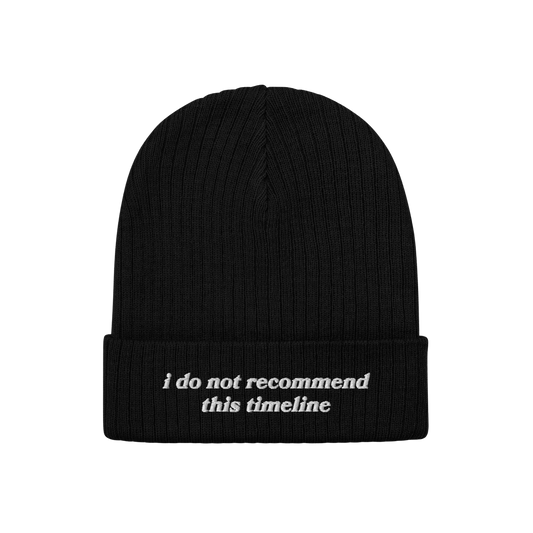 A black rib-knit Timeline Hat with a folded cuff, featuring white embroidered text: “i do not recommend this timeline.” P