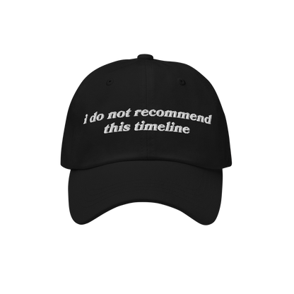 The Timeline Hat features a black, six-panel design with a curved brim, showcasing white embroidered text, i do not recommend