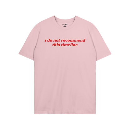 Timeline T-shirt in light pink with bold red text reading "i do not recommend this timeline" in a casual unisex style.