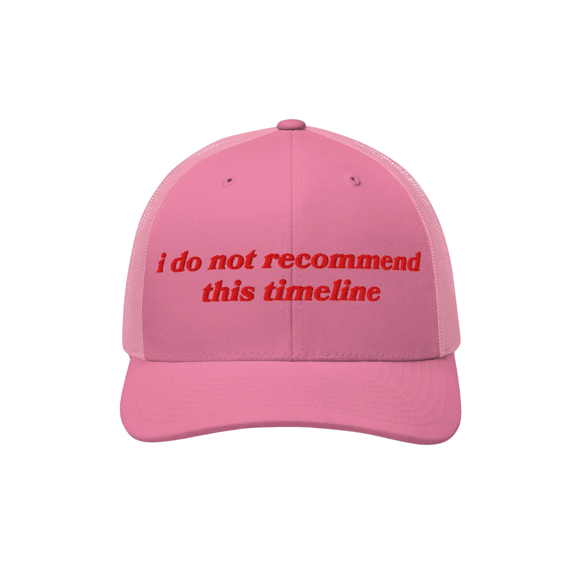 Pink mesh-back trucker cap with red embroidery reading “i do not recommend this timeline.” The Timeline Hat blends retro 